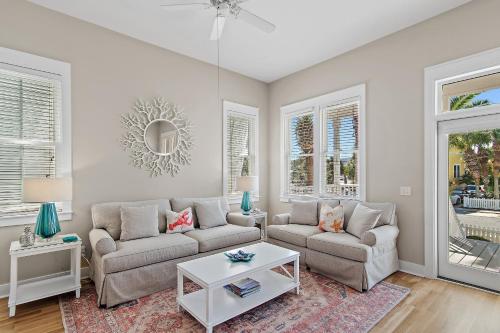 a living room with two couches and a table at Shore Fun At Destin Pointe Resort in Destin