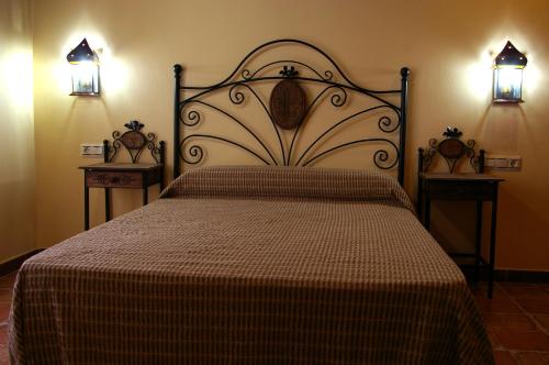 a bedroom with a large bed with two night stands at Villa de Xicar in Montejicar