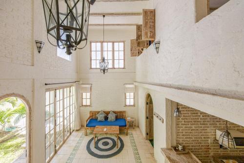 a large room with a blue bed and a table at M-Apartment in Badung