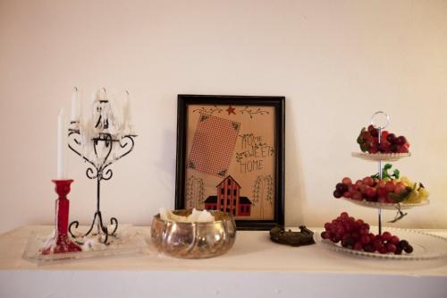 a table with two tiers of fruit and a picture at La Casa Sulla roccia in Enna