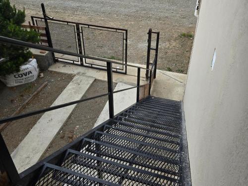 a stairway with a metal railing on a building at Apart Ayres -Planta alta in Río Gallegos