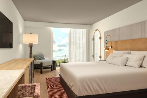 ein Hotelzimmer mit einem Bett und einem Stuhl in der Unterkunft Hotel Solaya in Scottsdale