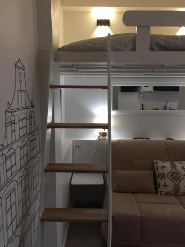 a living room with a bunk bed and a couch at Malakoff Petit Montrouge Beau Studio in Malakoff