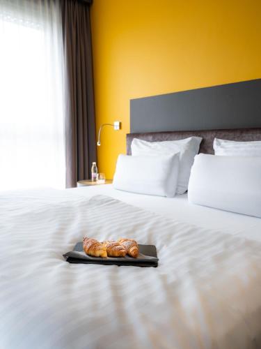 a tray of food sitting on top of a bed at Hotel City Maribor in Maribor