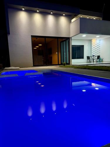 una piscina davanti a una casa di notte di casa com piscina a Sinop