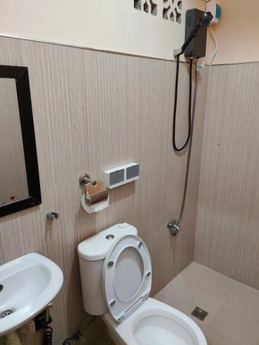 a bathroom with a toilet and a sink at Eve's Place Transient Apartment in Tanay