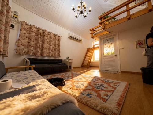 a living room with a couch and a rug at XCLUSIVE-7lAyutthayalX-7อยุธยา in Phra Nakhon Si Ayutthaya
