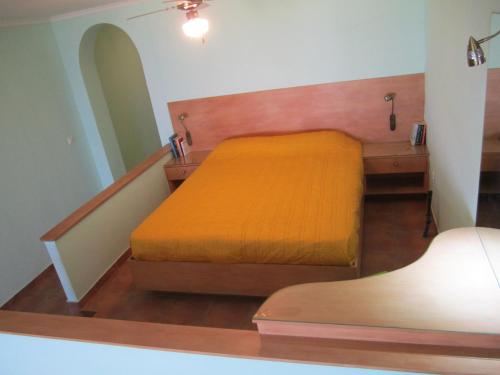 a bedroom with a bed and a dresser and a mirror at Santa Xenia in Galaxidhion