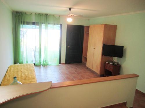 a living room with a couch and a tv and a room at Santa Xenia in Galaxidhion