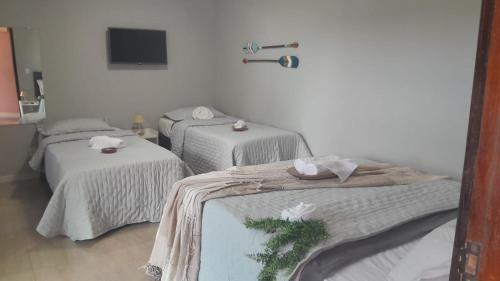 Ένα ή περισσότερα κρεβάτια σε δωμάτιο στο Pousada Canoa dos Anjos suítes