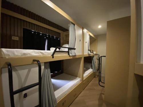 una habitación con dos literas y una ventana en BuenaSentro Hostel, en Manila