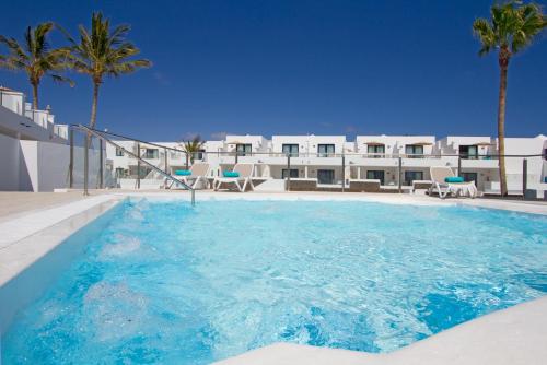 a large swimming pool in front of a building at Aqua Suites in Puerto del Carmen