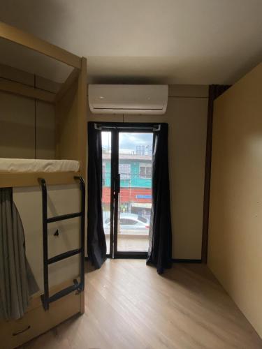 a room with two bunk beds and a window at BuenaSentro Hostel in Manila