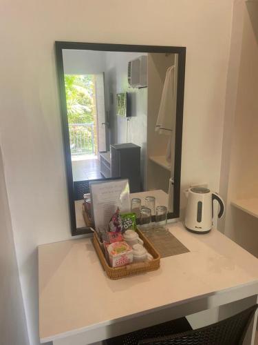 a counter with a tray of food and a mirror at Reef Waters Resort in Pilar