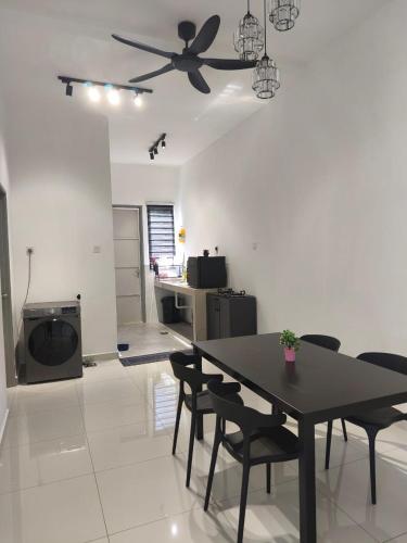 a dining room with a table and a ceiling fan at Inap kluster Alamanda in Kuala Kangsar
