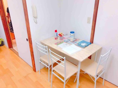 a dining room table with four chairs in a room at Hakone&Odawara private house Exclusive use in Odawara