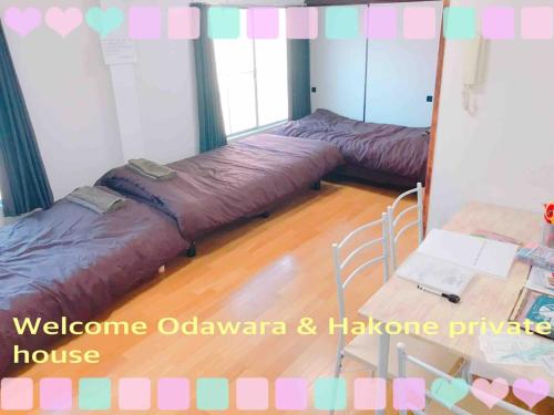 a room with two beds and a table with a mirror at Hakone&Odawara private house Exclusive use in Odawara