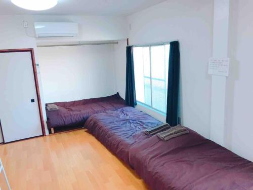 a bedroom with a bed and a window at Hakone&Odawara private house Exclusive use in Odawara