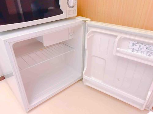an open refrigerator with a microwave on top of it at Hakone&Odawara private house Exclusive use in Odawara