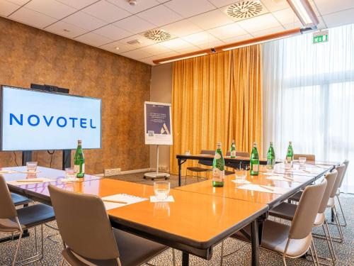 a conference room with a long table with bottles on it at Novotel Roma Est in Rome