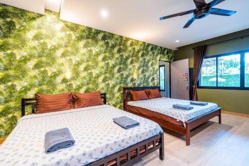 Postel nebo postele na pokoji v ubytování พาลาซิโอ เดอ ปราณี