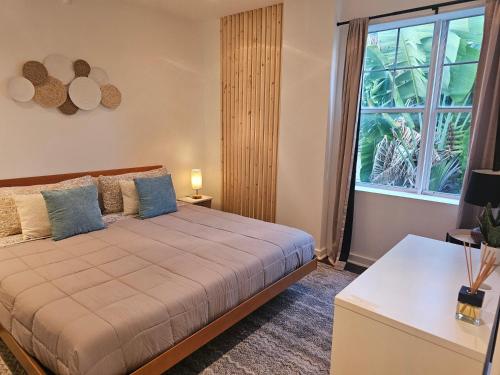 a bedroom with a bed and a large window at Bellio in Sobe in Miami Beach