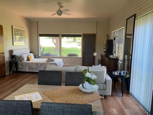 a living room with a couch and a table at Fi's Beach House in Port Macquarie