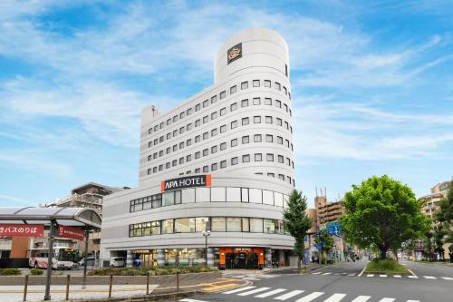 a large white building with a sign on it at APA Hotel Biwako Seta Ekimae in Otsu