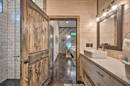 a bathroom with a wooden door and a sink at Moonlight Trail in Broken Bow