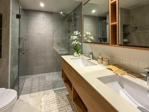 a bathroom with two sinks and a shower at Laguna Seaside 3 bed #84195 in Bang Tao Beach