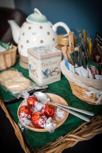 a table with a bowl of food and a teapot at Glan Llyn Farm House in Mold