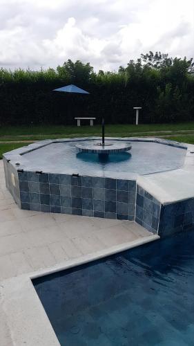 a large swimming pool with an umbrella in a park at Colombia Escape - Cafe Acapulco Extasis in Viterbo