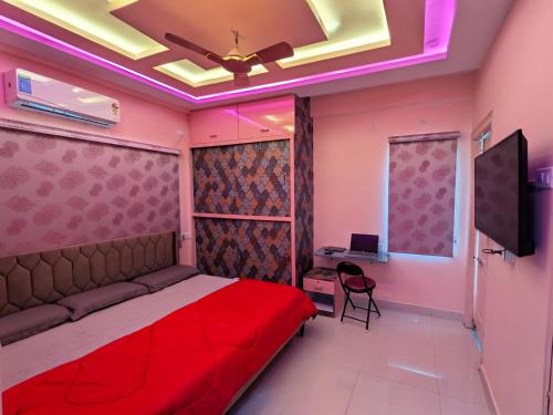 a bedroom with a red bed and a desk at PS Pristine Sea View Vacation Home in Bhīmunipatnam