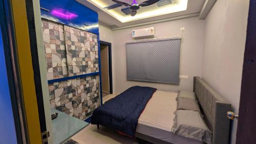 a small room with a bed and a glass door at PS Pristine Sea View Vacation Home in Bhīmunipatnam