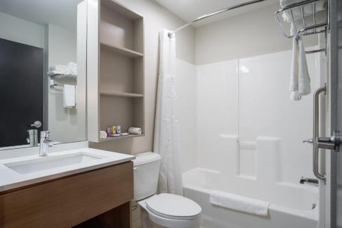 a bathroom with a sink and a toilet and a shower at Microtel Inn & Suites By Wyndham Moorhead Fargo Area in Moorhead