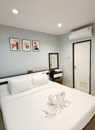 En eller flere senge i et værelse på Sampheng Apartment