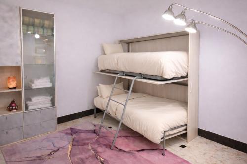 a room with two bunk beds and a lamp at MontBliss in Saint Vincent