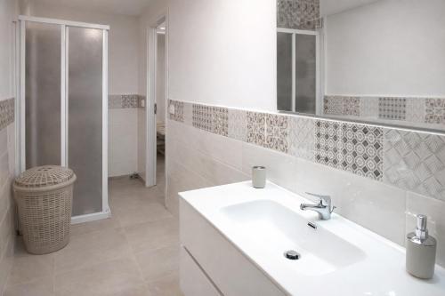 a white bathroom with a sink and a shower at MontBliss in Saint Vincent