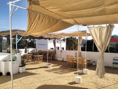 una grande tenda con tavoli e sedie sotto di essa di Roma House a Aswan