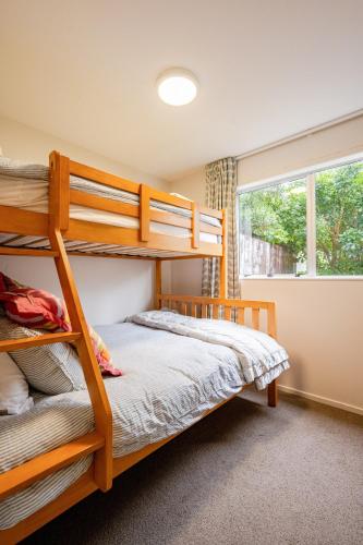 a bedroom with two bunk beds and a window at Sea View Batch in Tata Beach