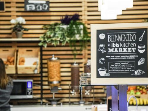 a sign for a bus kitchen market in a store at Ibis Girona in Girona