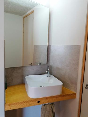 a bathroom with a white sink and a mirror at Casagrande in San José de Malpaso