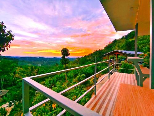 a balcony of a house with a view of the mountains at SZ SAMUI Glamping in Ban Sa Ket
