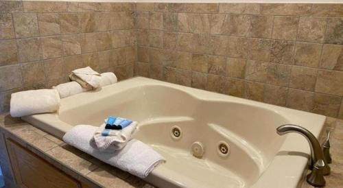 a white bath tub with towels on a counter at The Georgian Resort in Lake George