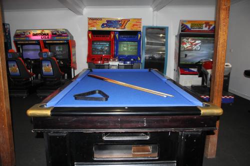a pool table with two cuesticks on top of it at Smugglers Cove Holiday Village in Forster