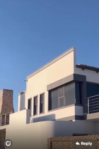 a rendering of a white house at Pluto Guesthouse in Walvis Bay