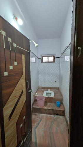 a bathroom with a toilet in a room at Ashirbad hotel in Digha