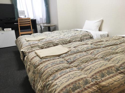Postel nebo postele na pokoji v ubytování Oustat Kokusai Hotel Tajimi