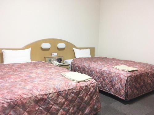 Postel nebo postele na pokoji v ubytování Oustat Kokusai Hotel Tajimi
