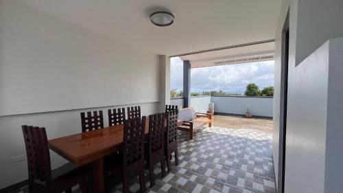a dining room with a wooden table and chairs at CEDA Hometel 